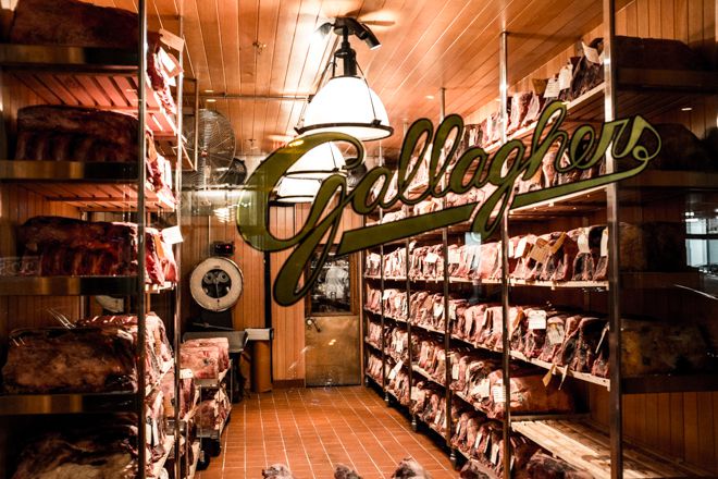 Cuts of dry-aged meat line the shelves of a walk-in refrigerator at Gallaghers Steakhouse in Midtown