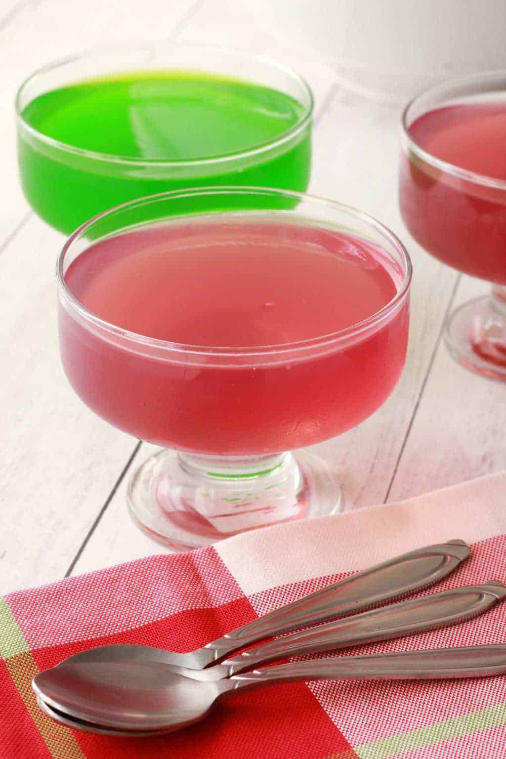 Red and green vegan jello in glass dishes.