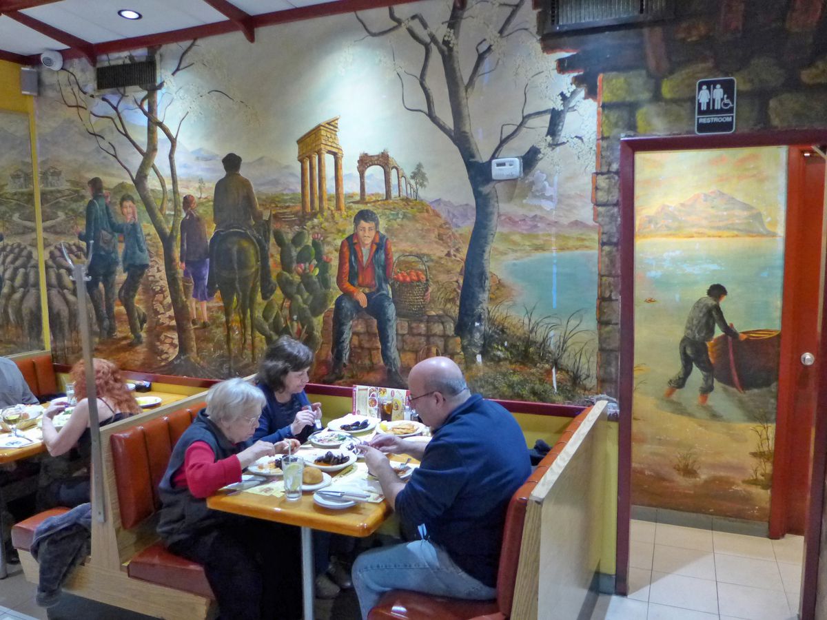 The dining room of Joe’s of Avenue U is adorned with Sicilian murals.