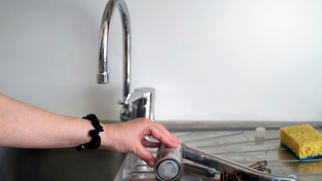 A person replacing their rv kitchen sink