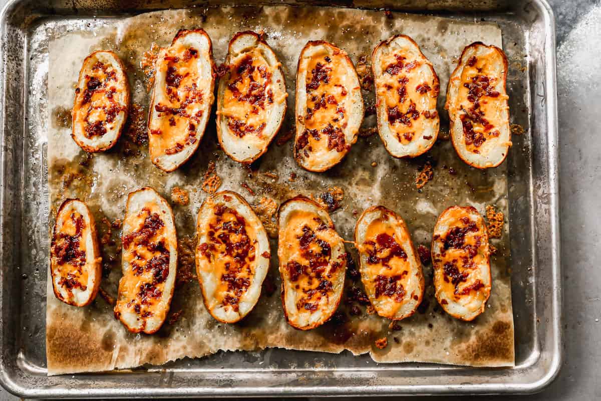 Baked potato skins with some of the potato scooped out and ready for the filling.