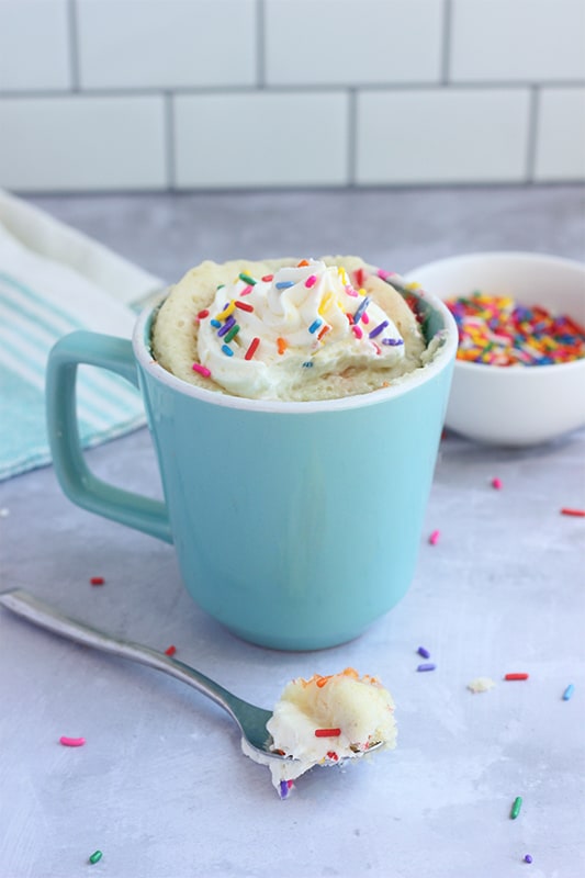 Cooked microwave mug cake in a blue mug