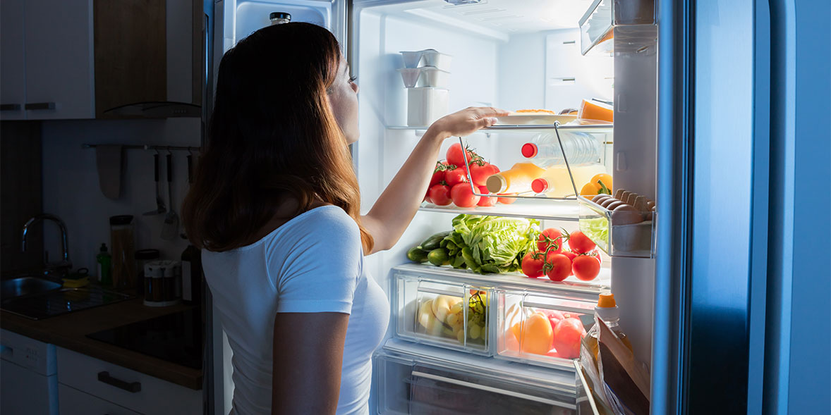Woman looking into a fridge